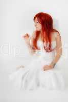 Woman with red hair as dreamy angel