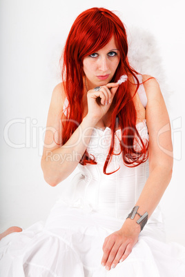 Woman with red hair as an angel with feathers in their hands