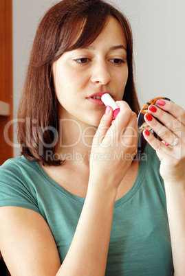 Young woman applying makeup