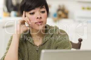 Pretty Mixed Race Woman Using Laptop at Home