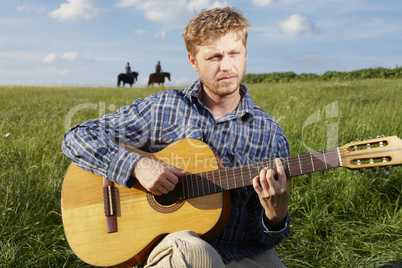 Man strumming a guitar