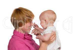 Cute baby touching mothers nose