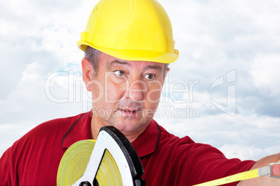 Construction worker with tape measure