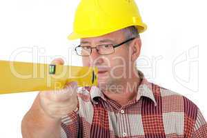 Construction worker looks at the spirit level