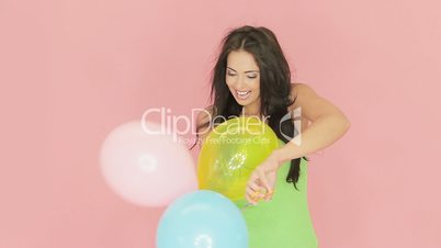 Beautiful woman playing with party balloons