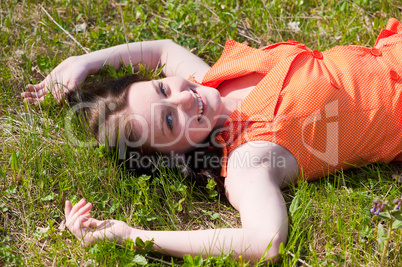 Pretty girl laying on grass