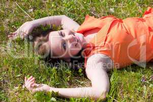 Pretty girl laying on grass