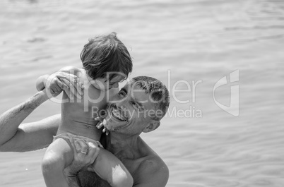 Baby and Father relaxing and joking at the Beach