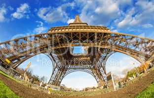 Wide angle upward view of Eiffel Tower in Paris