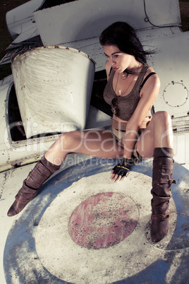 Sexy woman on aeroplane fuselage
