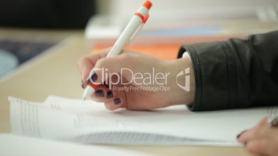Woman signing a document