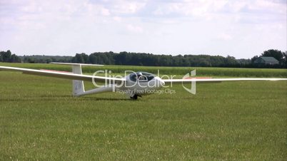 Competitor pilot rolls his glider on runway after final landing