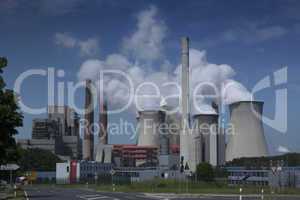 Brown coal power plant with huge cooling towers and steam