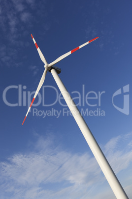 Wind Turbine with blue sky and the sun shining