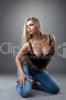 sexy young woman posing in black and jeans