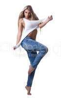 Sexy blonde woman posing in jeans and tank top