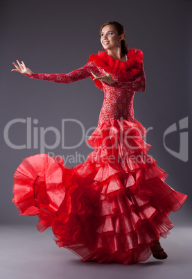 young woman flamenco dancer posing in red
