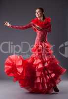 young woman flamenco dancer posing in red