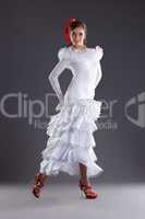 Young woman dance in white flamenco costume