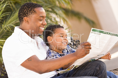 Mixed Race Father and Son Reading Park Brochure Outside