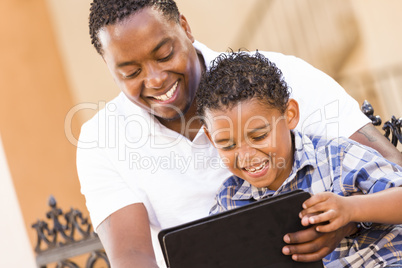 Mixed Race Father and Son Using Touch Pad Computer Tablet