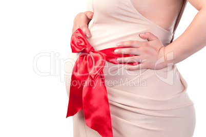 Pregnant Woman's Belly with Red Ribbon
