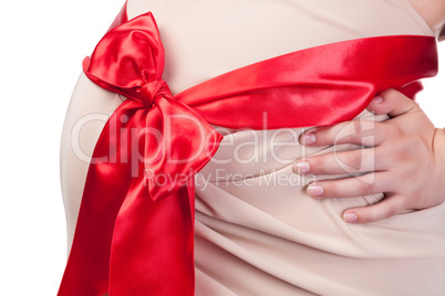 Pregnant Woman's Belly with Red Ribbon