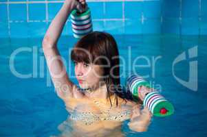 Pretty girl doing aqua aerobic exercise