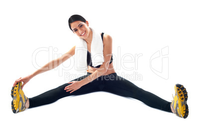 Young fit female trainer doing stretching