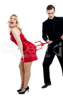 Evil guy poking sensual woman in red