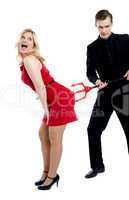 Evil guy poking sensual woman in red