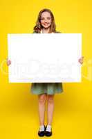 Teenager showing white blank billboard