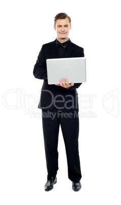 Smiling young man working on laptop