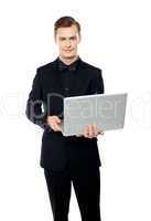 Casual young man with laptop