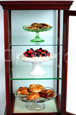 Shelf decorated by delicious desserts