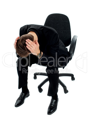 Frustrated young man sitting on chair