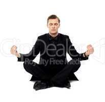 Smart young man in party wear doing yoga