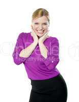 Excited woman posing with hands on chin