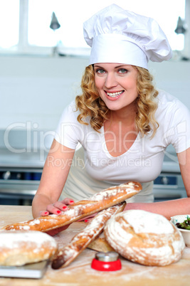 Cheerful female cook posing in kitchen