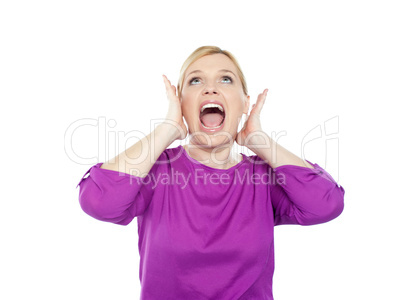 Woman shouting with hands on ears