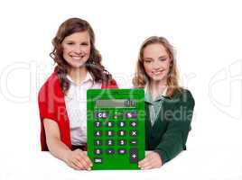 Girls showing big green calculator to camera