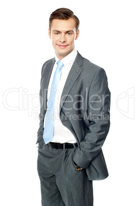 Smiling entrepreneur posing with hands in pocket