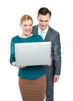 Business people enjoying funny videos on laptop