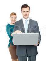 Woman pointing into laptop while guy holding it