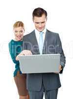 Smiling business people using laptop