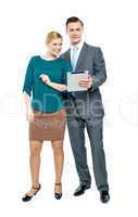 Businessman using tablet pc with secretary beside