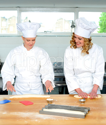 Senior chef teaching newbie female chef