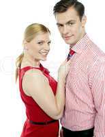 Girl in red holding businessman by his tie