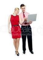 Female secretary pointing into laptop