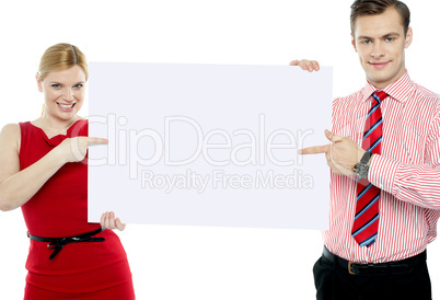 Business colleagues pointing at blank signboard